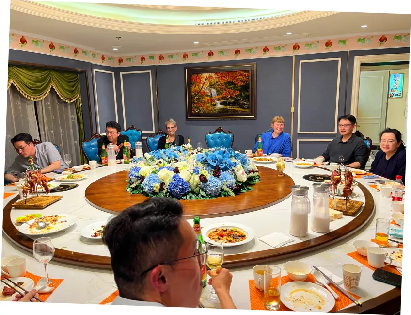 People having dinner around a round table