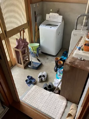 Laundry room with shoes, umbrellas and many other things