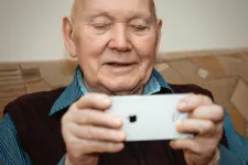 en äldre man med mobiltelefon. foto