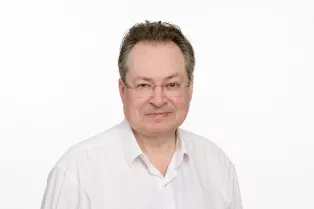 Porträttbild på Björn Slaug i vit skjorta.